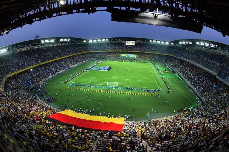YOKOHAMA, JAPAN:  Giant German (foreground) and Brazilian (background) flags are lowered onto the pitchof the International Stadium Yokohama, Japan, during the World Cup closing festivities before match 64 of the 2002 FIFA World Cup Korea Japan final opposing Germany and Brazil 30 June, 2002. This is the first time Germany and Brazil have met in a World Cup final. AFP PHOTO TORU YAMANAKA (Photo credit should read TORU YAMANAKA/AFP via Getty Images)